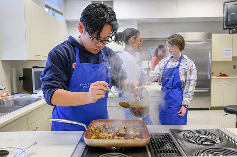 An MTSU nutrition and food sciences student prepares a meal in clas