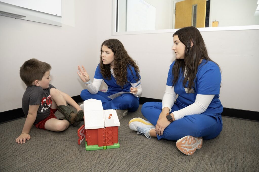 A MTSU Speech-Language, Pathology and Audiology student helps a patient in the on-campus clinic