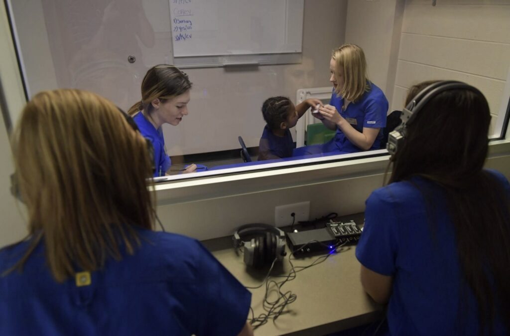 A MTSU Speech-Language, Pathology and Audiology student helps a patient in the on-campus clinic