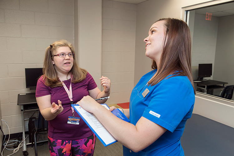 Student clinician Brandie White, right, works with client Kayla Capps at the MTSU Speech-Language-Hearing Clinic.